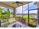 Relaxing screened lanai with comfortable seating and scenic views of lush landscaping and pond at 17704 Gawthrop Dr # 102, Bradenton, FL 34211