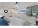 Bedroom features a queen-sized bed, contemporary décor, ceiling fan, and a beach scene on television at 17704 Gawthrop Dr # 102, Bradenton, FL 34211