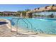Gorgeous pool with a rock waterfall feature, stainless steel handrails, and lots of lounge chairs, ideal for sunny days at 17704 Gawthrop Dr # 102, Bradenton, FL 34211