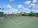 Well-maintained tennis court with lush green surface and clear blue skies, ready for a match at 17704 Gawthrop Dr # 102, Bradenton, FL 34211
