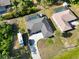 Aerial view of a single-Gathering home featuring a screened-in pool and a long driveway with an RV parked alongside at 18033 Edgewater Dr, Port Charlotte, FL 33948