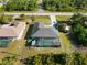 Aerial view of a single-Gathering home featuring a screened-in pool and a long driveway with an RV parked alongside at 18033 Edgewater Dr, Port Charlotte, FL 33948