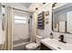 Cozy bathroom with tub and shower, vintage fixtures, tile floor, and vanity at 18033 Edgewater Dr, Port Charlotte, FL 33948
