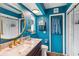 Stylish bathroom with a modern vanity, updated fixtures, marble counters and a large round mirror at 18033 Edgewater Dr, Port Charlotte, FL 33948