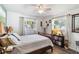Bright bedroom featuring natural light from two windows, hardwood floors, and a ceiling fan at 18033 Edgewater Dr, Port Charlotte, FL 33948
