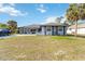 Charming single-story home with a well-maintained lawn and mature palm trees at 18033 Edgewater Dr, Port Charlotte, FL 33948
