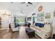 Well-lit living area with hardwood floors, neutral walls, and a door to the Primary suite at 18033 Edgewater Dr, Port Charlotte, FL 33948