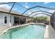 Beautiful pool area with an attached lanai and outdoor seating at 18033 Edgewater Dr, Port Charlotte, FL 33948