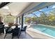 Enclosed pool area featuring a ceiling fan and access to the outside for dining or lounging at 18033 Edgewater Dr, Port Charlotte, FL 33948