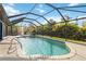 Screened pool area that has outdoor seating with lounge chairs next to the pool and jacuzzi at 18033 Edgewater Dr, Port Charlotte, FL 33948