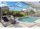 Inviting screened-in pool area featuring comfortable lounge chairs and a relaxing spa at 18033 Edgewater Dr, Port Charlotte, FL 33948