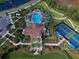 Overhead view of a community pool, clubhouse, and tennis courts at 208 Potenza Loop, Nokomis, FL 34275
