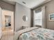 Comfortable bedroom showcasing neutral walls, wood-look floors, and light furnishings at 208 Potenza Loop, Nokomis, FL 34275