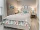 Cozy bedroom with a beach-themed decor, including artwork, lamps, and bedding at 208 Potenza Loop, Nokomis, FL 34275