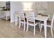 Bright dining area featuring a modern white table set, buffet and stylish decor at 208 Potenza Loop, Nokomis, FL 34275