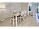 Bright dining area with a white table, chairs, and contemporary decor at 208 Potenza Loop, Nokomis, FL 34275