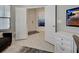 View of an entryway with light tile floors, an open doorway, and a dresser on the right at 208 Potenza Loop, Nokomis, FL 34275