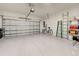 Spacious two car garage with epoxy flooring and an automatic door at 208 Potenza Loop, Nokomis, FL 34275