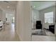 Hallway leading to a home office with neutral walls, modern tile flooring, and plenty of natural light at 208 Potenza Loop, Nokomis, FL 34275