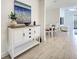 Open-concept layout showing a white cabinet, hallway, and dining area at 208 Potenza Loop, Nokomis, FL 34275