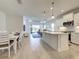 Open-concept layout with a kitchen island, dining area, and living room at 208 Potenza Loop, Nokomis, FL 34275