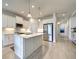Modern kitchen with a large island, stainless steel appliances, and white cabinetry at 208 Potenza Loop, Nokomis, FL 34275
