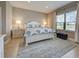 Comfortable main bedroom with a king bed, neutral tones, and abundant natural light at 208 Potenza Loop, Nokomis, FL 34275