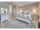 Bright main bedroom featuring neutral decor and ample space for relaxation and rest at 208 Potenza Loop, Nokomis, FL 34275