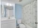 Cozy bathroom featuring a vanity with sink, toilet, and shower/tub combo with a shower curtain at 208 Silver Lake Dr # 101, Venice, FL 34292