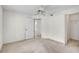 Well-lit bedroom with carpet, a ceiling fan, a closet, and an open doorway to the rest of the home at 208 Silver Lake Dr # 101, Venice, FL 34292