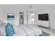 Bright staged bedroom with carpet and two doorways, one to the bathroom and the other to the kitchen at 208 Silver Lake Dr # 101, Venice, FL 34292