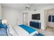 Nicely decorated bedroom featuring a bed, dresser, TV, closet, and doorway to the rest of the home at 208 Silver Lake Dr # 101, Venice, FL 34292