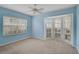Bedroom with blue walls featuring a large bay window offering plenty of natural light at 208 Silver Lake Dr # 101, Venice, FL 34292