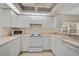 Bright kitchen with white appliances, cabinets, and decorative ceiling detail, creating a welcoming atmosphere at 208 Silver Lake Dr # 101, Venice, FL 34292