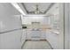 Well-lit kitchen with white cabinets, appliances, and decorative ceiling detail, creating a welcoming atmosphere at 208 Silver Lake Dr # 101, Venice, FL 34292