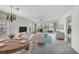 Staged living room featuring a sitting area, a dining area, windows, and a view to the outside at 208 Silver Lake Dr # 101, Venice, FL 34292