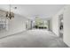 Large living room featuring a fan, windows, sliding door, and a glimpse to the outside at 208 Silver Lake Dr # 101, Venice, FL 34292