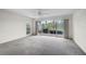 Bright and airy living room with large sliding glass doors offering scenic views of the outdoors at 208 Silver Lake Dr # 101, Venice, FL 34292