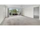 Spacious living room with sliding glass doors to the outside and large windows providing ample light at 208 Silver Lake Dr # 101, Venice, FL 34292