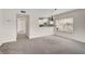 Open-concept space with view to kitchen, features large window with natural light and neutral tones at 208 Silver Lake Dr # 101, Venice, FL 34292