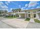 Exterior shot of a condo community featuring covered parking, palm trees, and well-maintained landscaping at 208 Silver Lake Dr # 101, Venice, FL 34292