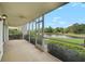 Covered patio with screened enclosure overlooking picturesque waterfront views and tropical landscaping at 208 Silver Lake Dr # 101, Venice, FL 34292