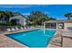 Community pool featuring ample lounge chairs, umbrellas, and a relaxing atmosphere on a sunny day at 208 Silver Lake Dr # 101, Venice, FL 34292