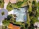 A bird's eye view capturing the home's unique roofline and design, along with its screened pool and well-kept surroundings at 2196 Muskogee Trl, Nokomis, FL 34275
