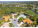 An aerial shot showcases the home nestled within a vibrant community near lush golf course and serene ponds at 2196 Muskogee Trl, Nokomis, FL 34275