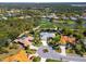 An aerial view highlighting the home's location in a beautiful community, surrounded by ponds, golf course, and landscaping at 2196 Muskogee Trl, Nokomis, FL 34275