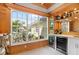 A stylish bar area offers a view of the property and convenient wine refrigerators for entertaining at 2196 Muskogee Trl, Nokomis, FL 34275