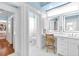 Bright bathroom featuring a vanity with LED lighting, and a view to an adjacent toilet room at 2196 Muskogee Trl, Nokomis, FL 34275
