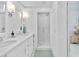 Bright bathroom with dual sinks, a large glass shower, and white cabinets and trim at 2196 Muskogee Trl, Nokomis, FL 34275