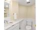 Small bathroom features vanity with sink, a toilet and white tile, with a mirror on the wall at 2196 Muskogee Trl, Nokomis, FL 34275
